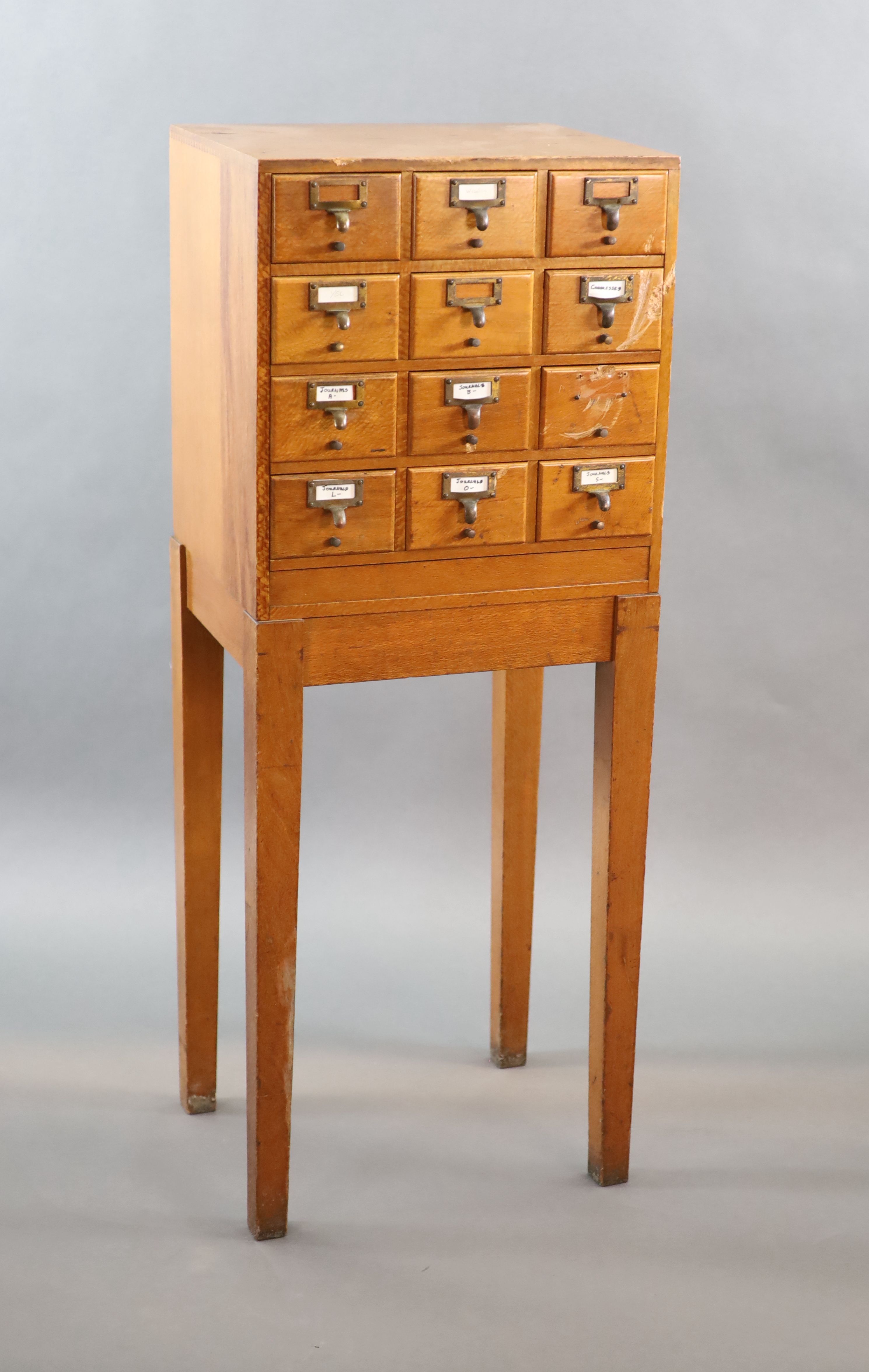 An early 20th century golden oak filing chest on stand, fitted twelve drawers, width 50cm depth 41cm height 131cm